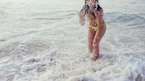 smiling young woman playing with waves