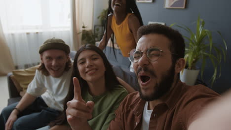 happy diverse friends taking group selfies at home