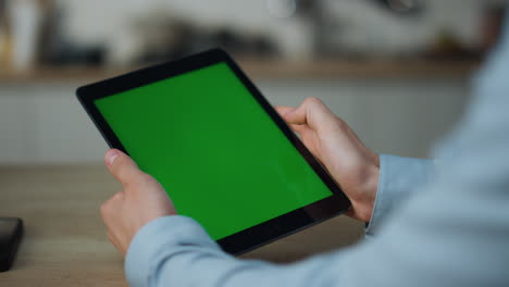 hands touching greenscreen tablet searching information sitting at table closeup