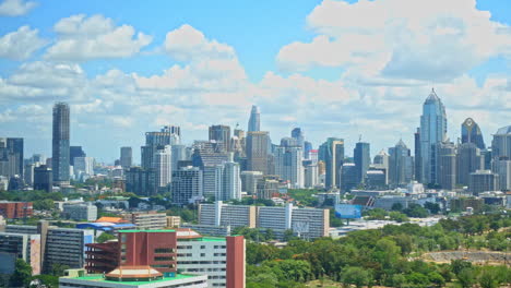 Time-lapse-of-clouds-racing-through-the-blue-sky-over-the-urban-skyline-of-Bangkok,-Thailand