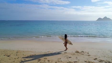 Female-surfer-with-surfboard-walking-in-the-beach-4k