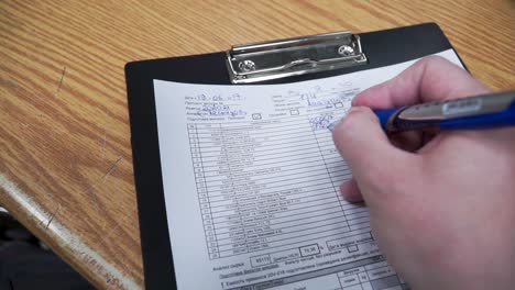 person filling out a form or checklist