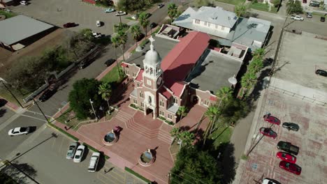 Aerial-top-view-view-over-"Our-Lady-of-Guadalup"-Church,-one-of-the-oldest-landmarks-in-Mission,-Texas,-dating-back-to-1899