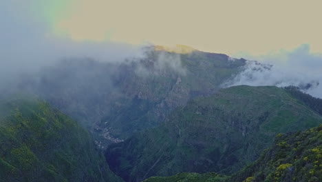 Aerial-view-panning-down-over-rugged-cloudy-valley-on-Madeira-Portugal