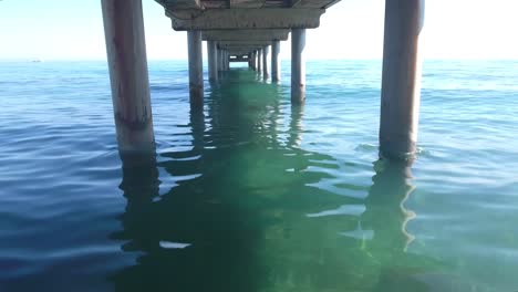 amazing shot flying under pier with drone, risky flight with high risk of losing drone