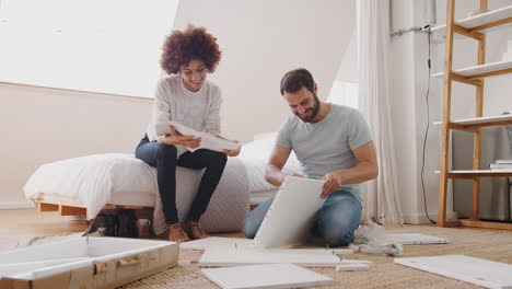 couple in new home putting together self assembly furniture