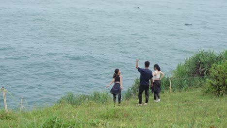 friends enjoying the ocean view from a cliff