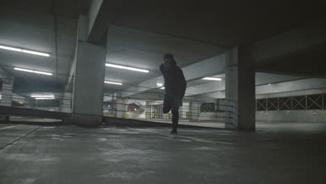 african american man jumping a fence in a parking garage in slow motion