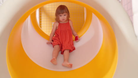 Adorable-Hesitant-3-Year-Old-Toddler-Girl-Got-Stuck-Inside-Colorful-Slide-Tube-at-Indoor-Playground