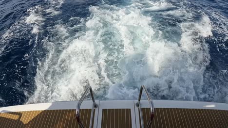 Slow-motion-of-boat-travelling-away-from-the-coast-of-Tenerife,-Canary-islands