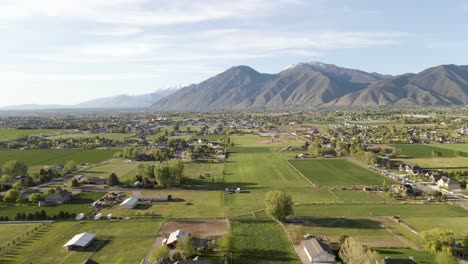 aerial view of mapleton and spanish fork cities in utah with wasatch mountain range in background