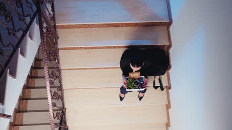 Top-view-of-unemployed-woman-holding-box-of-stuff