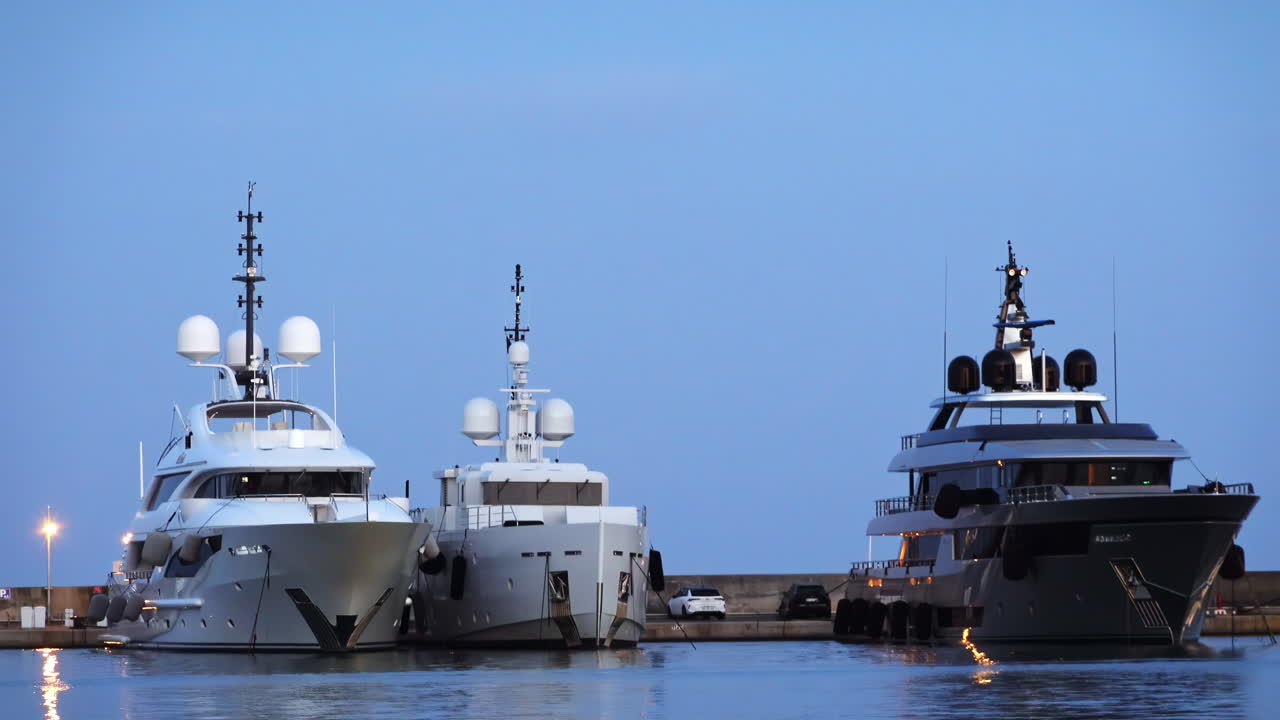 White boats docked in the Port de Cannes in the evening