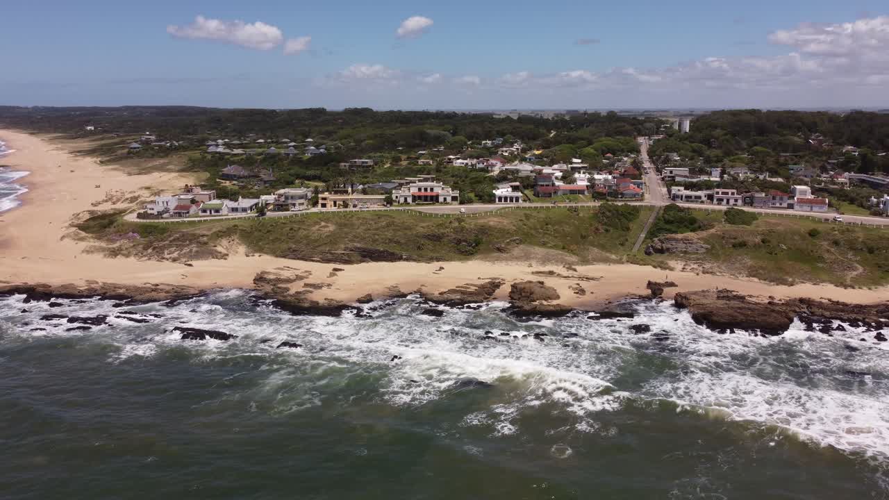 olas rompiendo en la costa rocosa del pueblo de la pedrera en un día soleado, uruguay