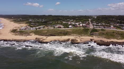 waves breaking on rocky coast of la pedrera village on sunny day, uruguay