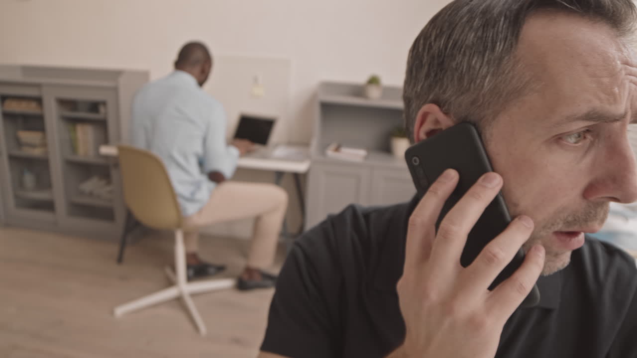 Nervous Manager Talking on Cellphone