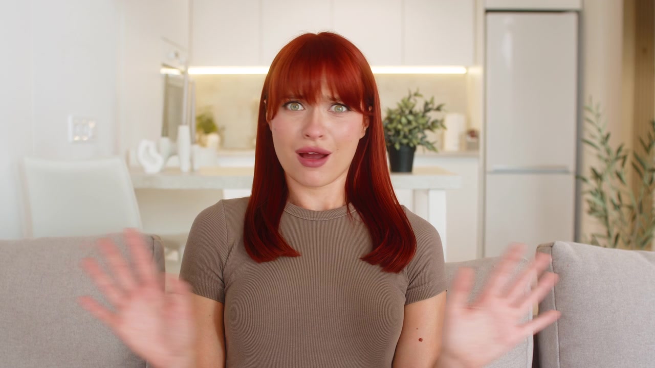 Young woman waves hands to camera disagrees rejects request shows disappointment disapproval firmly