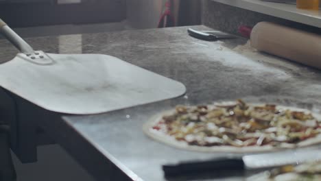 Raw-pizza-on-shovel-before-baking