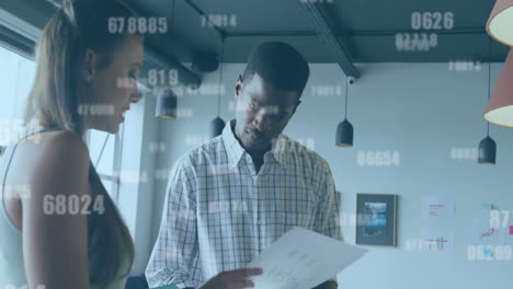 animation of changing numbers against diverse man and woman discussing over document at office