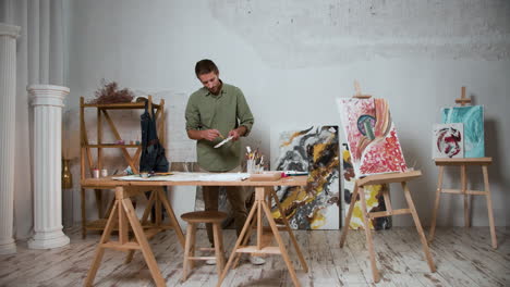 man mixing colors on the palette