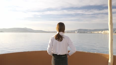 dolly out shot, showing the sea and then a girl gazing upon it