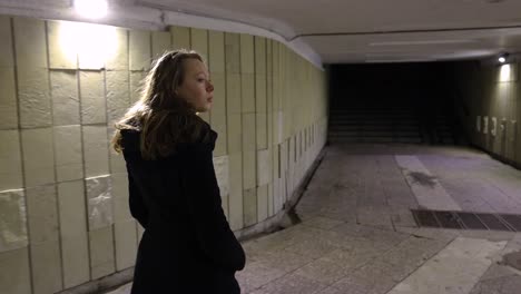 girl walking out from the underground passage in the night