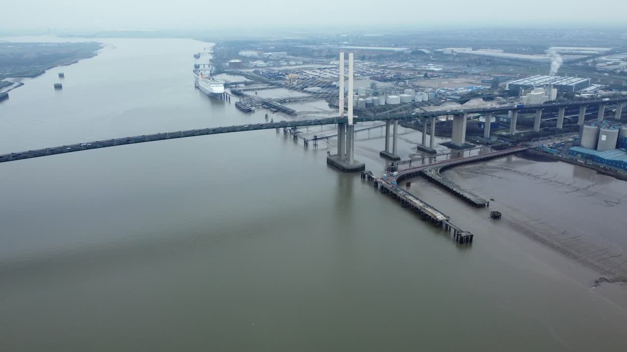 Aerial view of a bridge over a river with industrial area