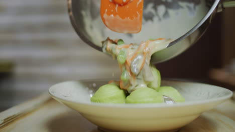 garnish is poured onto the dumplings. traditional ukrainian dish