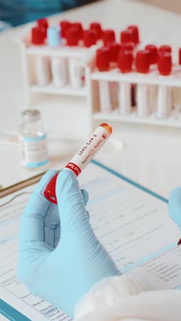 doctor preparing a blood test tube for analysis in a clinical setting