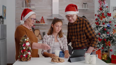 happy family watching online xmas movie on tablet computer enjoying holiday season