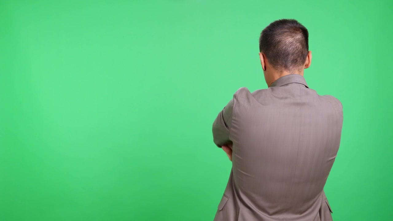 Rear view of businessman stretching his neck and back