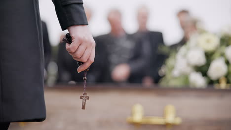 Funeral,-religion-and-hands-with-rosary