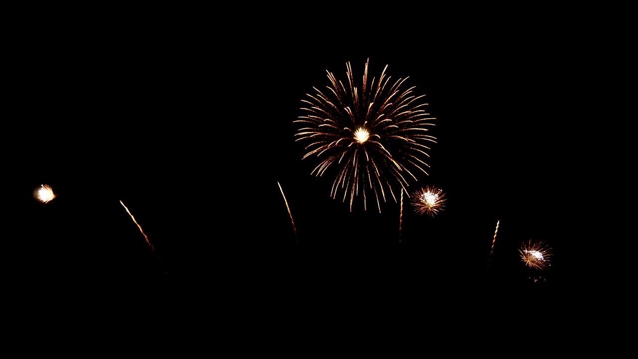 4K. seamless loop of real golden fireworks festival in the sky display at night during national holiday, new year party or celebration event