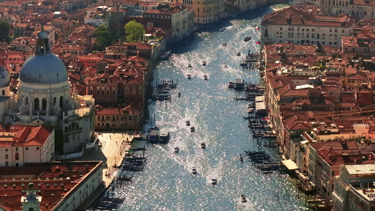 Aerial drone view of boats moving around Venice City, Italy on a sunny day