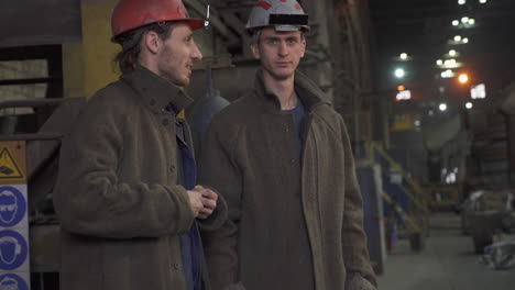 factory workers in conversation