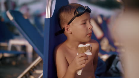 child eating waffle cone ice cream at the beach