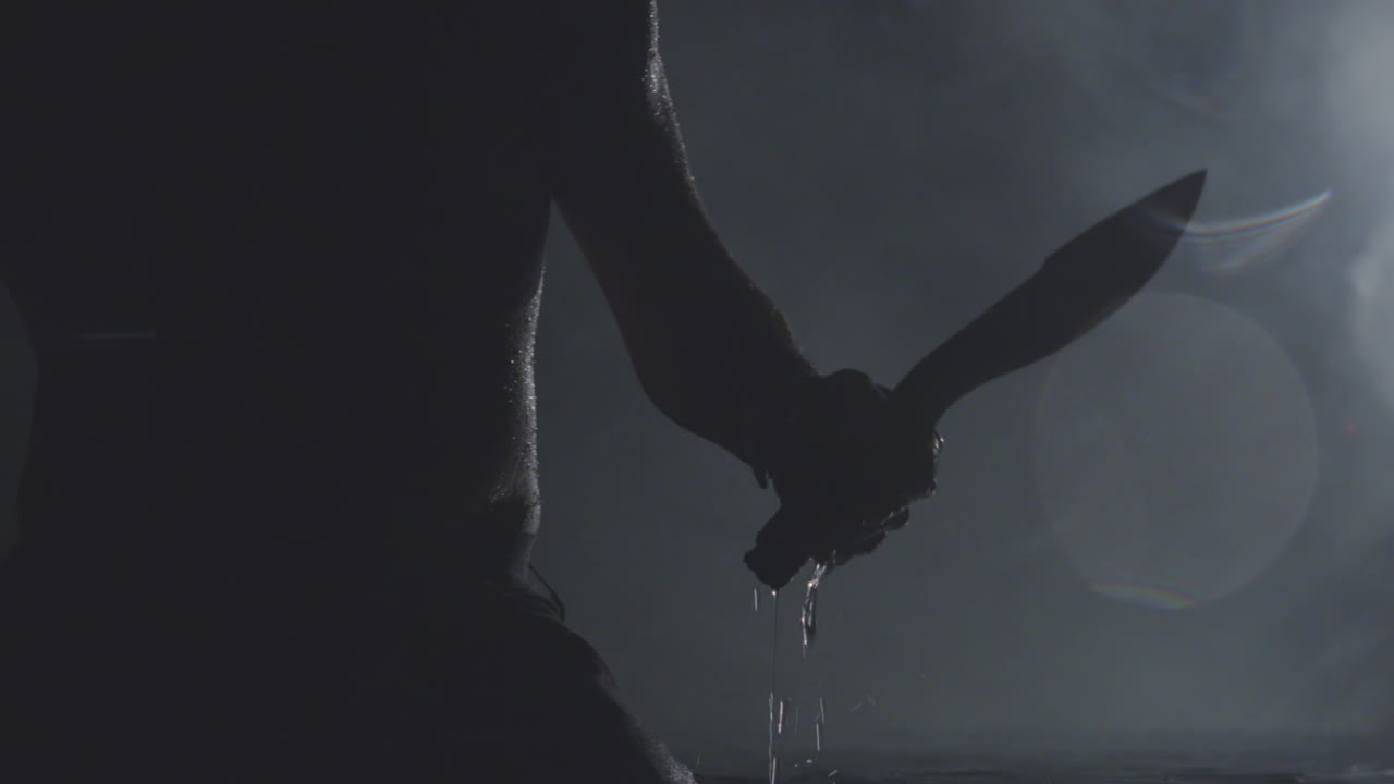 A person dips a knife in water