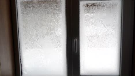 a glass door with full of snow and ice on it