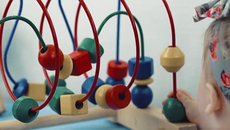 child plays with a multi-colored toy 26