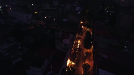 aerial drone fly above night streets of santiago, chile, lastarria residential neighborhood in cloudy evening