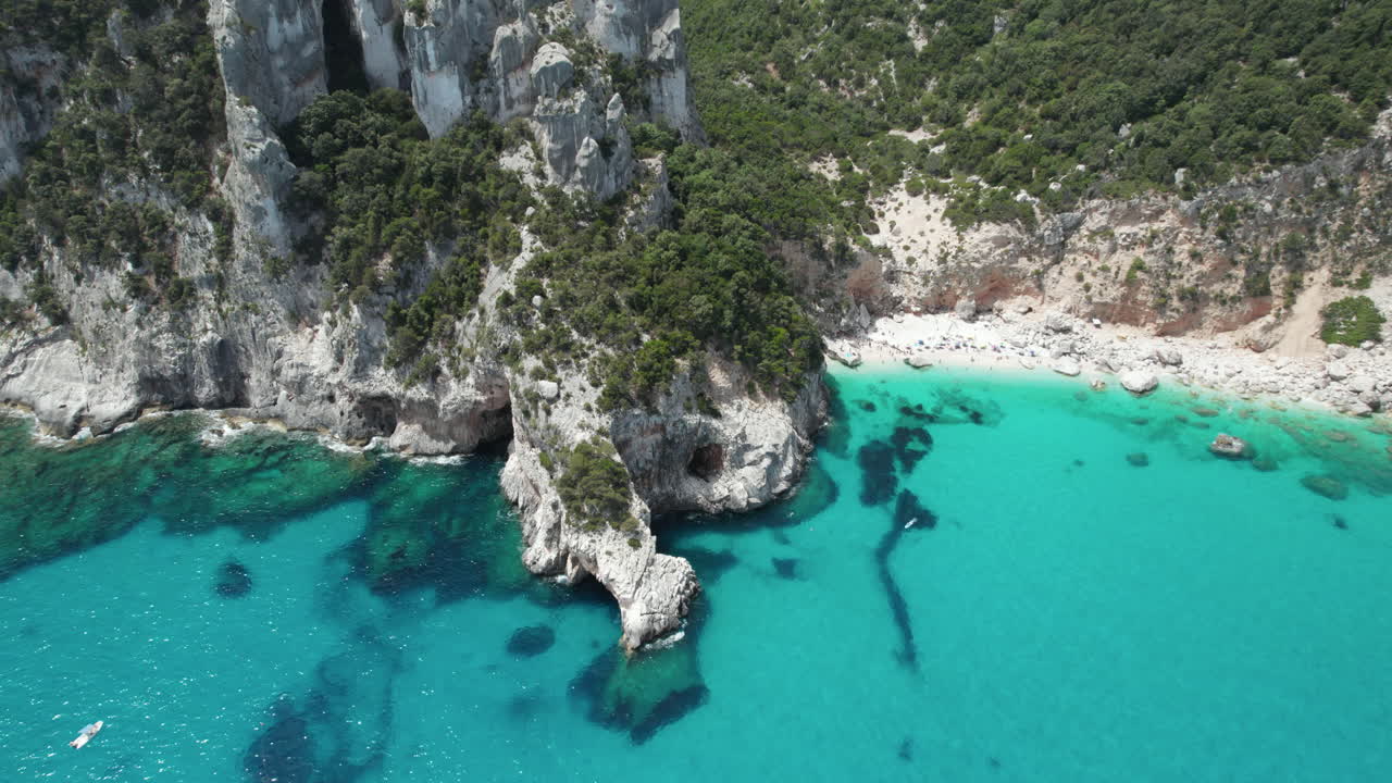 Aerial drone video of tropical paradise beach and sea cliffs in the mediterranean, Cala Goloritzè, Sardinia, Italy