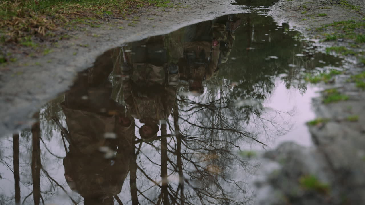 Soldiers in a Forest Reflecting in a Puddle