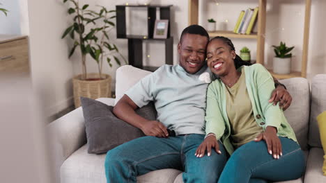 love, hug and couple watching tv on a sofa