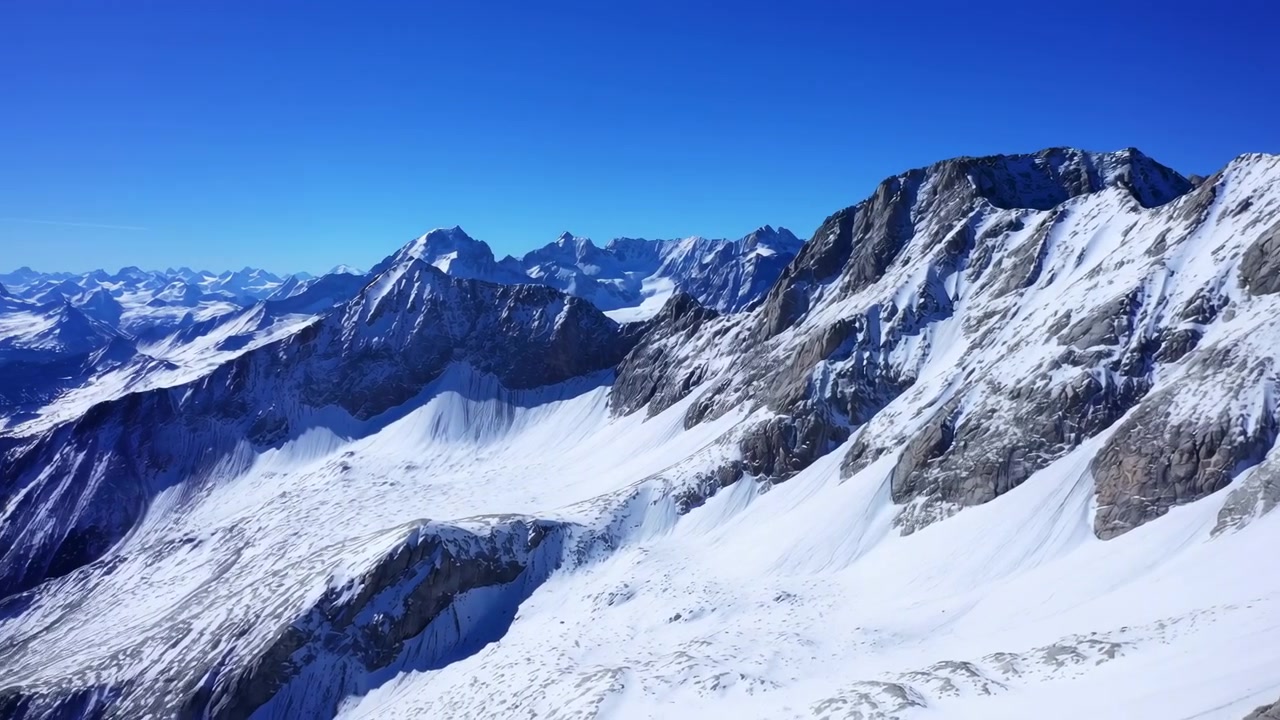 Karlı Alp dağ panoraması, parlak gökyüzü, ufka uzanan geniş güneşli zirveler ve buzullar, keskin detaylar.