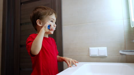 adorable toddler boy is cleaning his teeth. cute child performing his hygiene at home.
