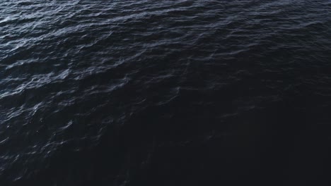 Aerial-view-of-moving-water-of-a-Patagonian-lake