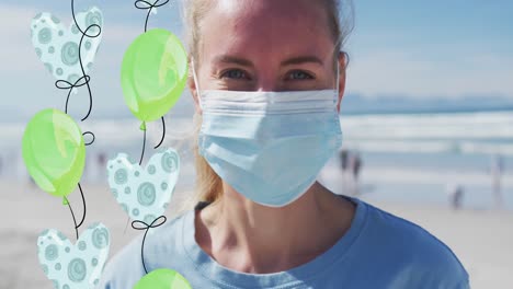 Animation-of-balloons-over-caucasian-woman-in-face-mask-on-beach