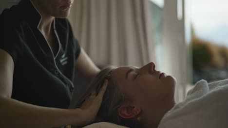 Professional-head-massage-in-soft-focus-with-iconic-Mount-Cook-and-tranquil-blue-lake-as-a-stunning-backdrop