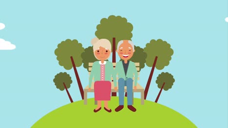 una pareja de ancianos sentada en un banco en el parque