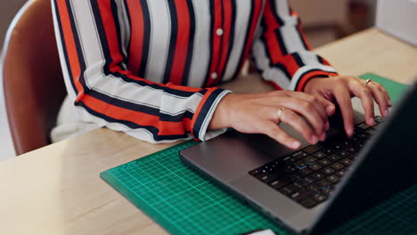 Closeup,-hand-and-laptop-for-e-commerce-in-office